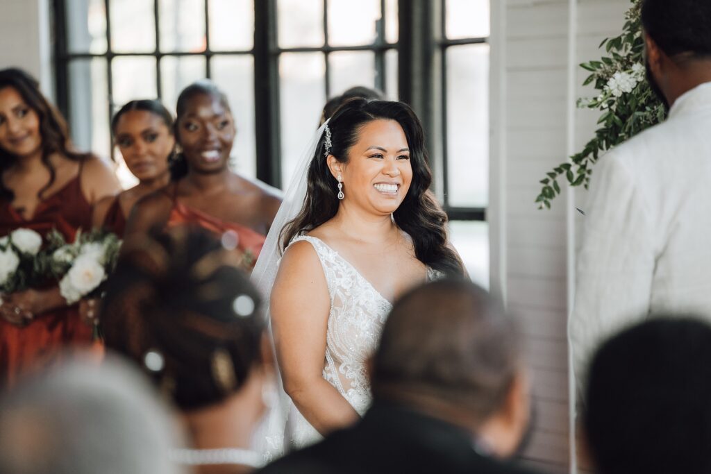 bride smiling at the altar at their Ozari Nashville wedding