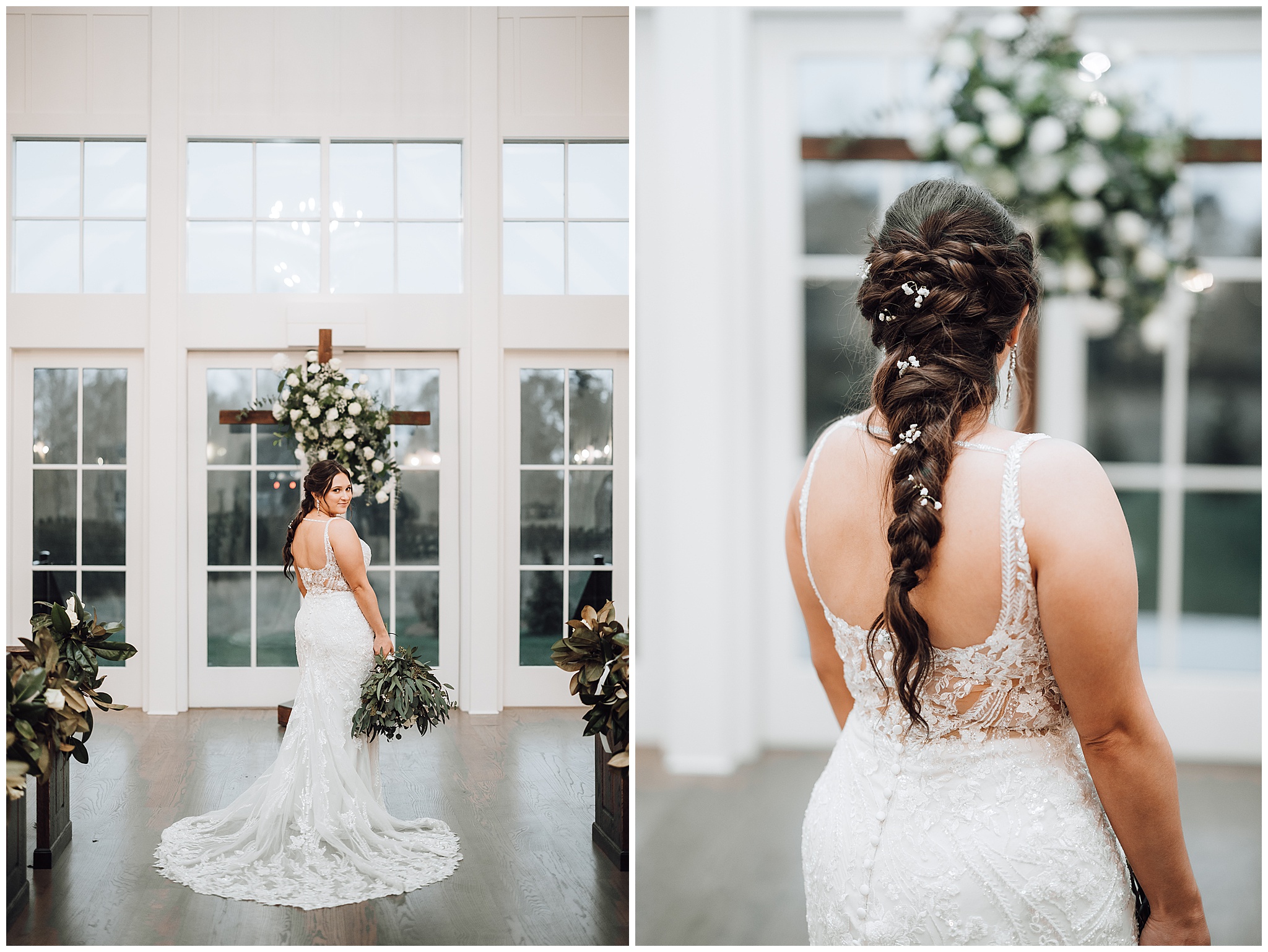 Bride in a white lace dress and train stands in front of a wooden cross covered in white flowers holding her bouquet at The Venue at Birchwood