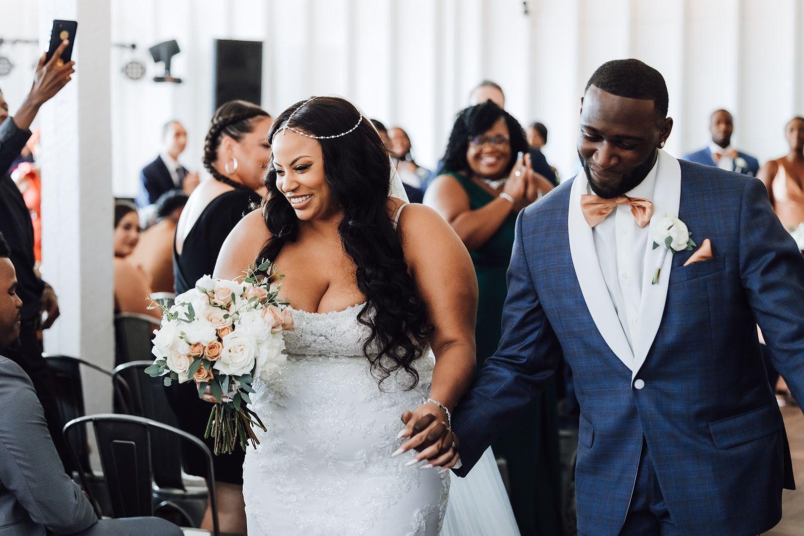 Newlyweds exit their ceremony down the aisle while their guests celebrate 14Tenn Wedding