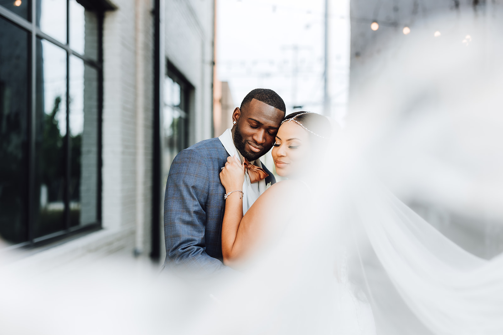 Newlyweds dance in an alley while the veil flows around them 14Tenn Wedding