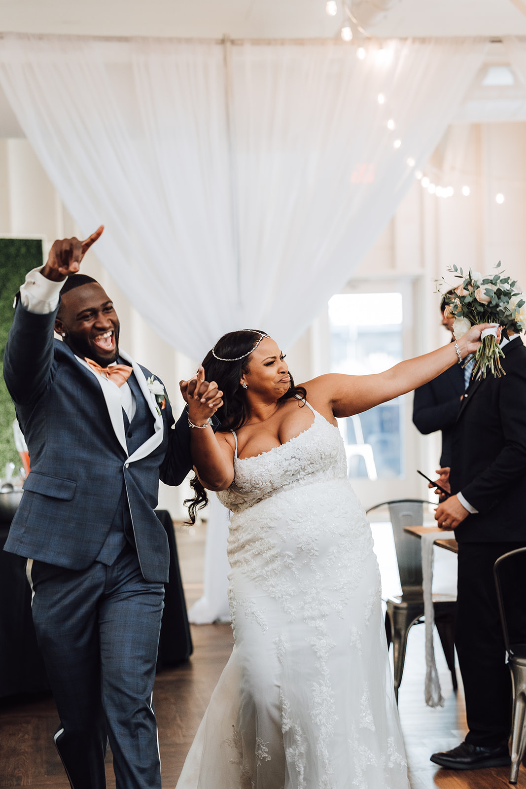 Newlyweds celebrate while entering their reception