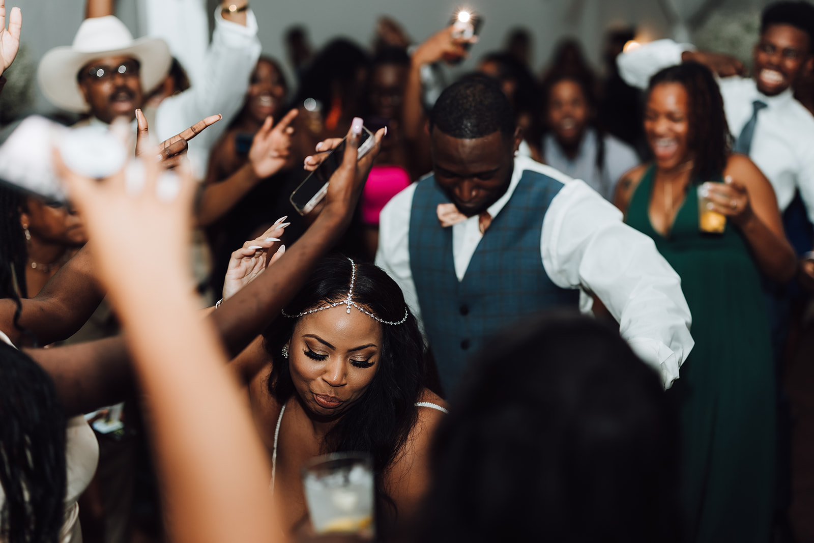 Newlyweds dance surrounded by family and friends