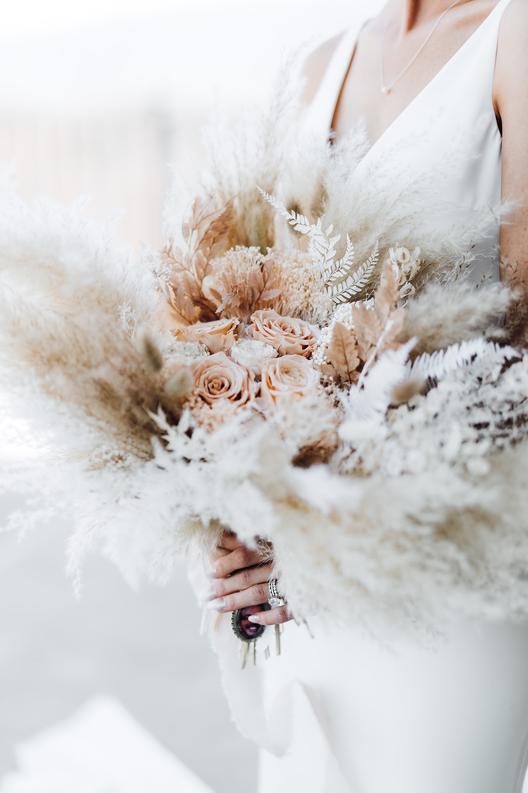 Details of a bride holding her bouquet